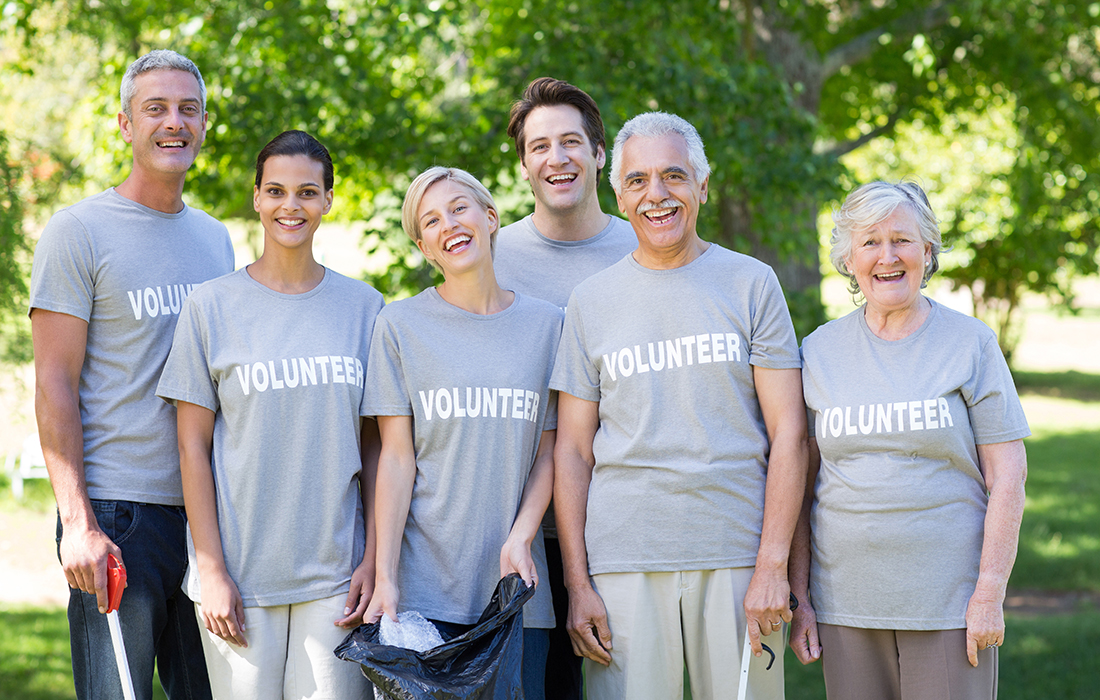 Happy volunteer family smiling at the camera
